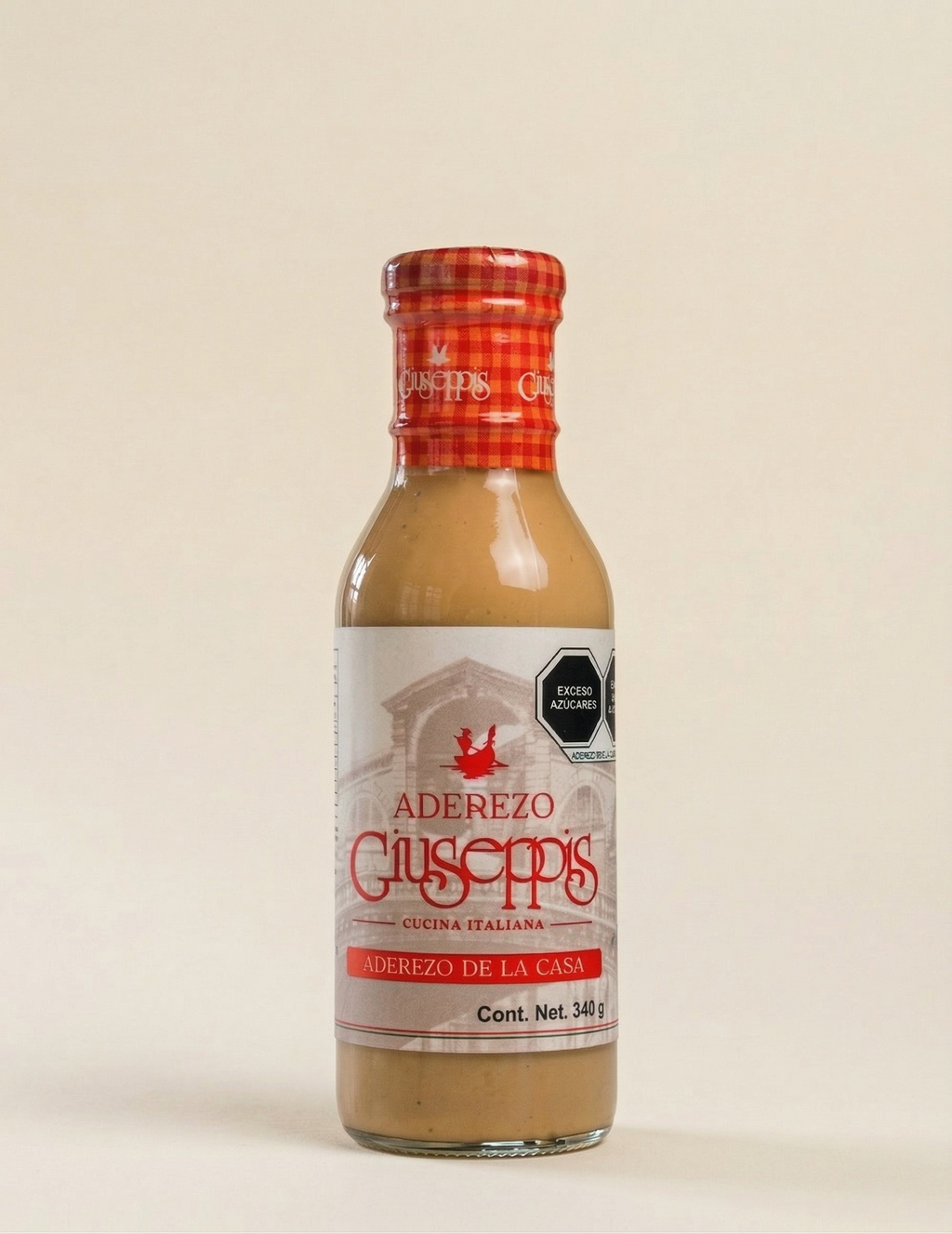 Botella de Aderezo Giuseppis 340 g sobre fondo crema