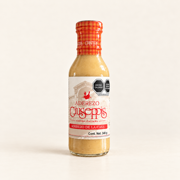 Aderezo Giuseppis 340 g, botella centrada con etiqueta actual sobre fondo crema